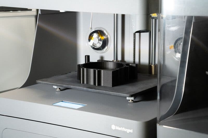 3D printer printing a black part