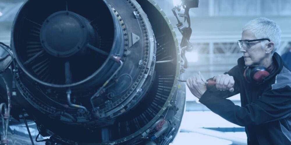 woman fixing aircraft wing