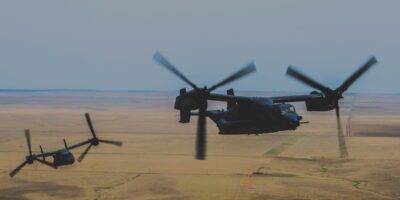 military helicopter flying over land