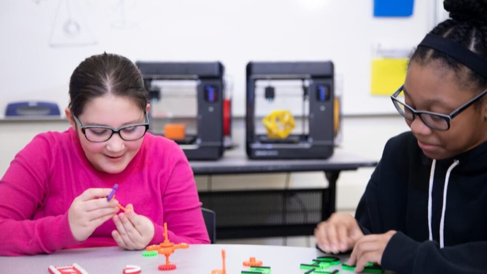 Two kids with 3D printed toys